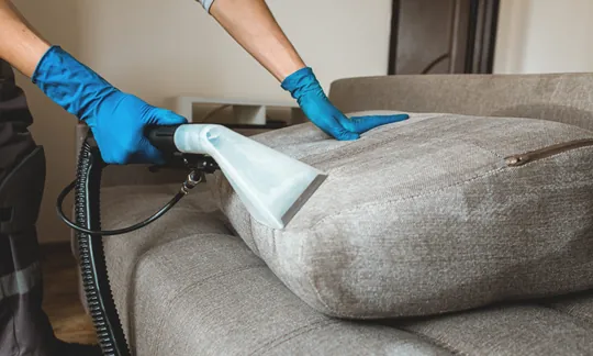 Sectional couch cushion being cleaned