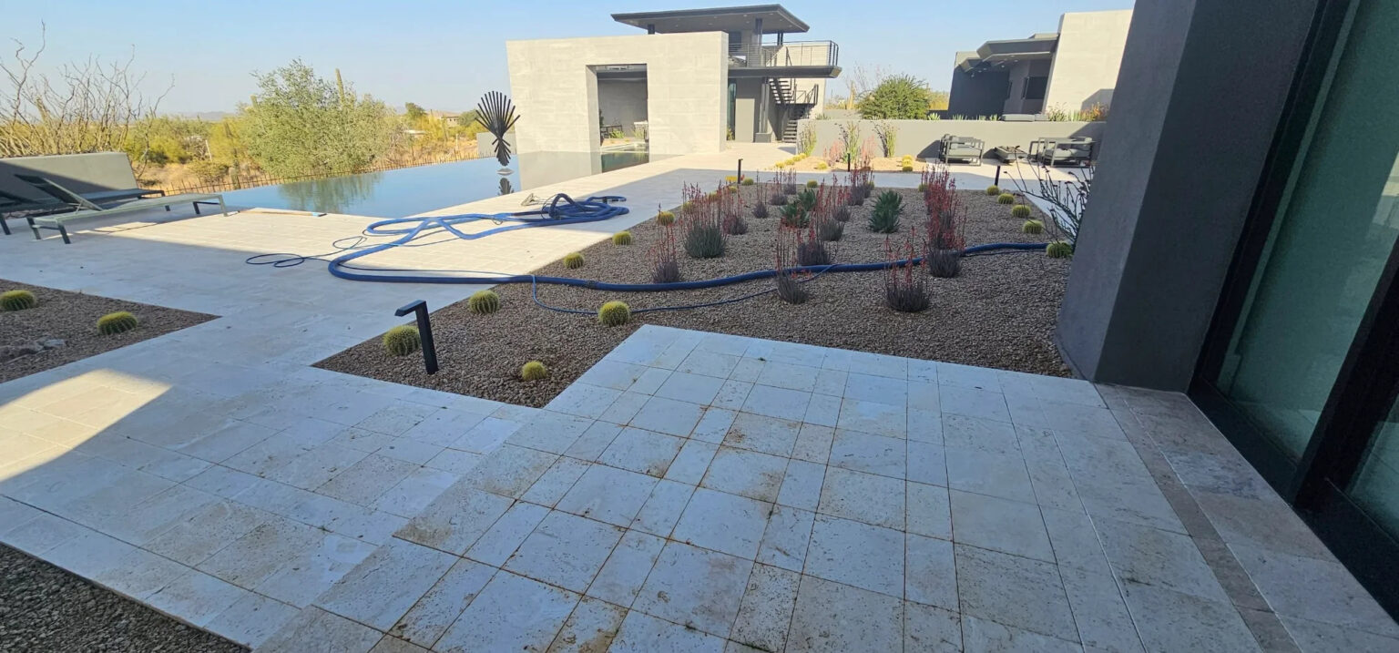 Weathered travertine patio before cleaning