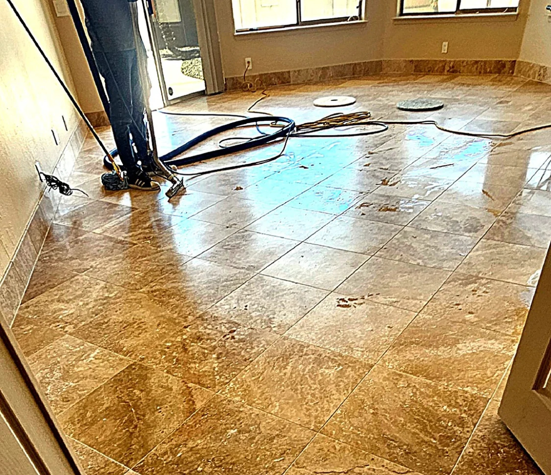 Dirty travertine tile floor before professional cleaning